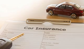 Car insurance form, car key and a model car